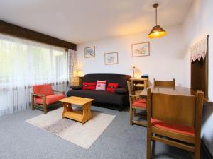 a living room with a couch and a table at Apartment Ringstrasse - Utoring-2 by Interhome in Leukerbad