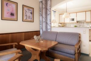 a living room with a couch and a table at Appartements Lüftenegger in Mauterndorf