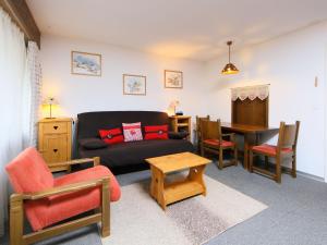 a living room with a couch and a table at Apartment Ringstrasse - Utoring-2 by Interhome in Leukerbad