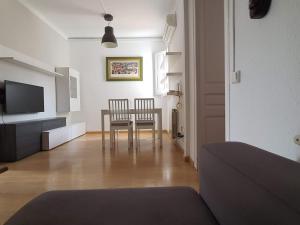 a living room with a table and two chairs at Apartment Sagrada Familia Grassot - Industria by Interhome in Barcelona