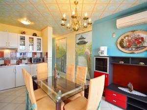 a dining room with a glass table and chairs at Apartment Ivana-2 by Interhome in Raslina