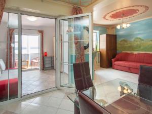 a living room with glass doors and a red couch at Apartment Ivana-2 by Interhome in Raslina +17 photos