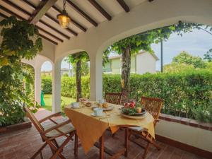 a table and chairs sitting on a patio with a table and chairs at Holiday Home Bona by Interhome in Forte dei Marmi