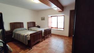 a bedroom with two beds and a window at Casa Guigas in Pragelato