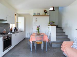 a kitchen and dining room with a table and chairs at Holiday Home La Casetta - CCO107 by Interhome in Colico