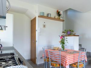 a kitchen with a table with chairs and a stove at Holiday Home La Casetta - CCO107 by Interhome in Colico