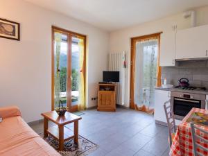a kitchen and living room with a couch and a table at Holiday Home La Casetta - CCO107 by Interhome in Colico