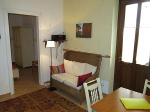 a living room with a couch and a table at Apartment Casa Vacanza Cascina Lovera-1 by Interhome in Belvedere Langhe