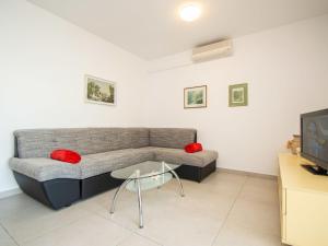 a living room with a couch and a table at Holiday Home Tramontana by Interhome in Sovlje