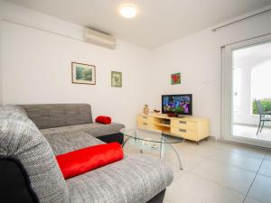 a living room with a couch and a tv at Holiday Home Tramontana by Interhome in Sovlje