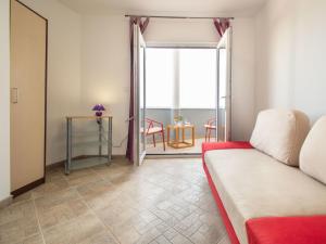 a living room with a couch and a table at Apartment Ivana-3 by Interhome in Raslina