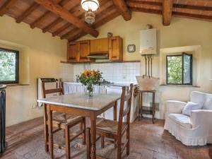 a kitchen and dining room with a table and chairs at Holiday Home Casottino - PAA131 by Interhome in Palaia