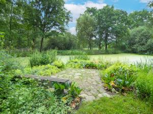 a garden with a stone path in front of a pond at Apartment Rittergut Wurschen by Interhome in Wurschen