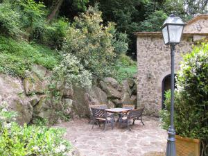 a table and two chairs and a street light at Holiday Home Il Pozzo by Interhome in Podere Caminino