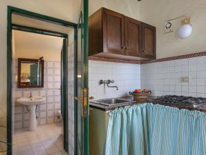 a kitchen with a sink and a stove at Holiday Home Terra Bianca - PAA136 by Interhome in Palaia