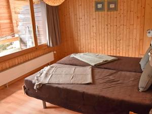 a bedroom with a bed and a window at Apartment Parc C013 by Interhome in Champex