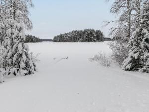 un campo innevato con alberi sullo sfondo di Holiday Home Kuusela by Interhome a Juhanala