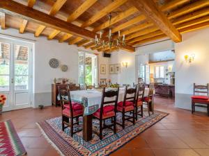 eine Küche und ein Esszimmer mit Tisch und Stühlen in der Unterkunft Villa Ca' del Vento by Interhome in Montù Beccaria