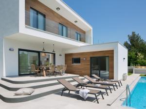 a villa with a swimming pool and a house at Villa Santa Marina by Interhome in Vabriga