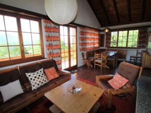 a living room with a couch and a table at Chalet Gallina by Interhome in Castelveccana