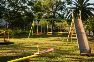 a playground with a seesaw and a swing at Paradise Village in Roda