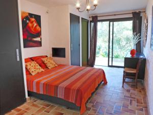a bedroom with a bed and a desk and a window at Villa La Maison du Midi by Interhome in Saint-Aygulf