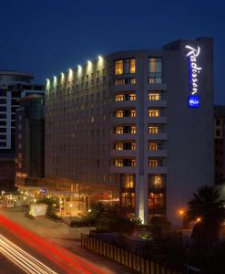 
a city street at night with a large building at Radisson Blu Hotel, Addis Ababa in Addis Ababa
