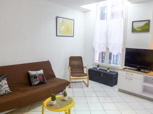 a living room with a couch and a tv at Apartment Vieux Nice by Interhome in Nice