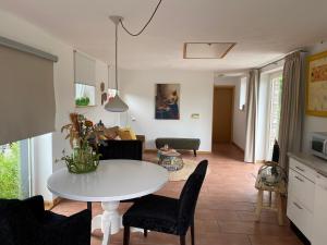 a living room with a white table and chairs at Heidehof Pension B & B in Elten