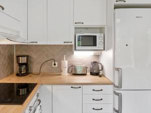 A kitchen or kitchenette at Holiday Home Hiukanhelmi by Interhome