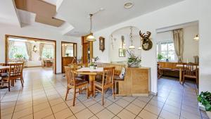 a kitchen and dining room with a table and chairs at Landhaus am Rehwald in Donzdorf