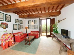 a living room with a red couch and a table at Holiday Home Le Nuvole by Interhome in Pucciarelli