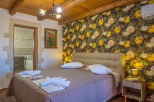 a bedroom with a bed with towels on it at Villa George in Kambánion