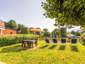 a group of chairs and a table in the grass at Holiday Home Residenza Agrifoglio-11 by Interhome in Luino