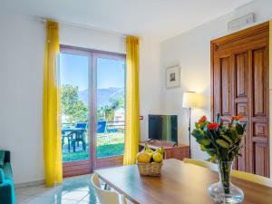 a living room with a table with a vase of flowers at Holiday Home Residenza Agrifoglio-11 by Interhome in Luino