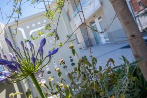 a bunch of flowers in front of a building at Hotel Baby in Rimini