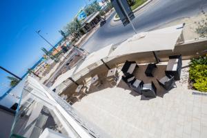 an overhead view of a table and chairs with an umbrella at Hotel Baby in Rimini