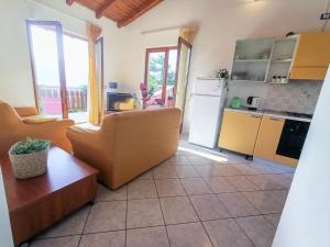 a living room with a couch and a kitchen at Apartment Residenza Agrifoglio-6 by Interhome in Luino +30 photos