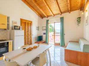 a kitchen and living room with a table and chairs at Apartment Residenza Agrifoglio-7 by Interhome in Luino