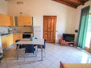 a kitchen with a table and chairs in a room at Apartment Residenza Agrifoglio-7 by Interhome in Luino