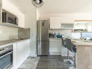 una cocina con refrigerador de acero inoxidable en Apartment Les Portes de Pyla by Interhome, en La Teste-de-Buch