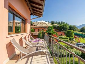 a row of chairs sitting on a balcony with a view at Apartment Residenza Agrifoglio-13 by Interhome in Luino