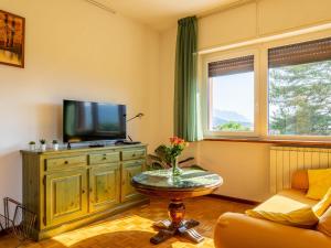 a living room with a tv and a couch and a table at Apartment Residenza Agrifoglio-13 by Interhome in Luino