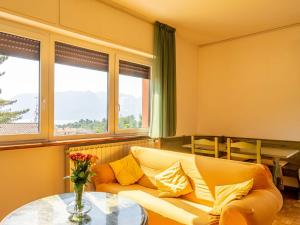a living room with a couch and a table at Apartment Residenza Agrifoglio-13 by Interhome in Luino