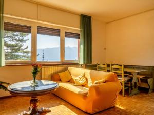 a living room with a couch and a table at Apartment Residenza Agrifoglio-13 by Interhome in Luino