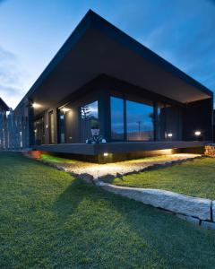 a house with a black facade at night at Abraços dos Avós - Casas de aldeia in Viana do Castelo