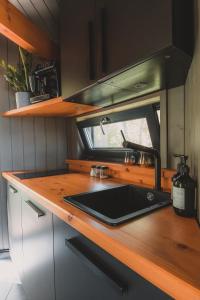 a kitchen with a sink and a counter top at Hekso treehouse 