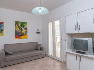 a living room with a couch and a tv at Apartment Mari by Interhome in Olbia
