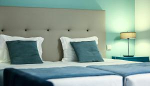 Uma cama ou camas num quarto em Grão Vasco - Historic Hotel and SPA