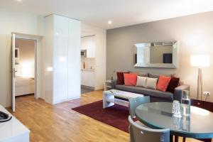 a living room with a couch and a table at The Levante Rathaus Apartments in Vienna